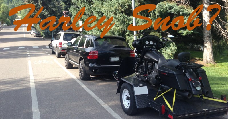 A guy towing his bagger by means of Porsche in Aspen, CO on a beautiful sunny day. A guy towing his bagger by means of Porsche in Aspen, CO on a beautiful sunny day.